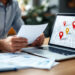 Business owner researching how to choose an SEO agency near me on a laptop