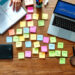 A marketer mapping out an SEO content strategy with keyword clusters and a content calendar on a whiteboard