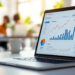 Business owner reviewing SaaS marketing agency options with funnel and CRM dashboards on screen